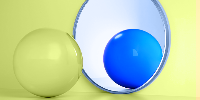 Yellow ball looking at a blue ball in a mirror