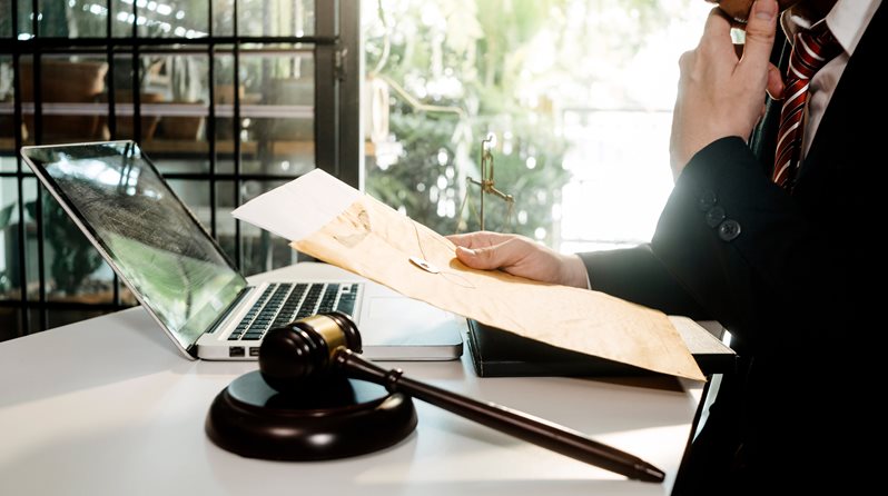 lawyer holding document envelope