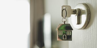 Tiny house on keys. Mortgage concept