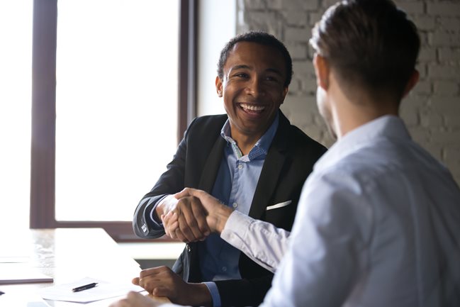 happy business people shaking hands agreement